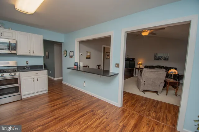 a kitchen with stainless steel appliances kitchen island granite countertop a refrigerator and a stove top oven