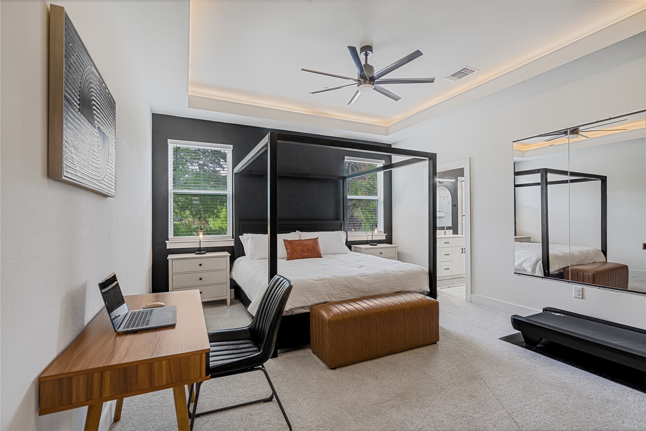 1811 Webberville Road, Unit 4103 Austin, TX 78721 - Photo 11 of 35 a bedroom with a bed a couch and a large mirror