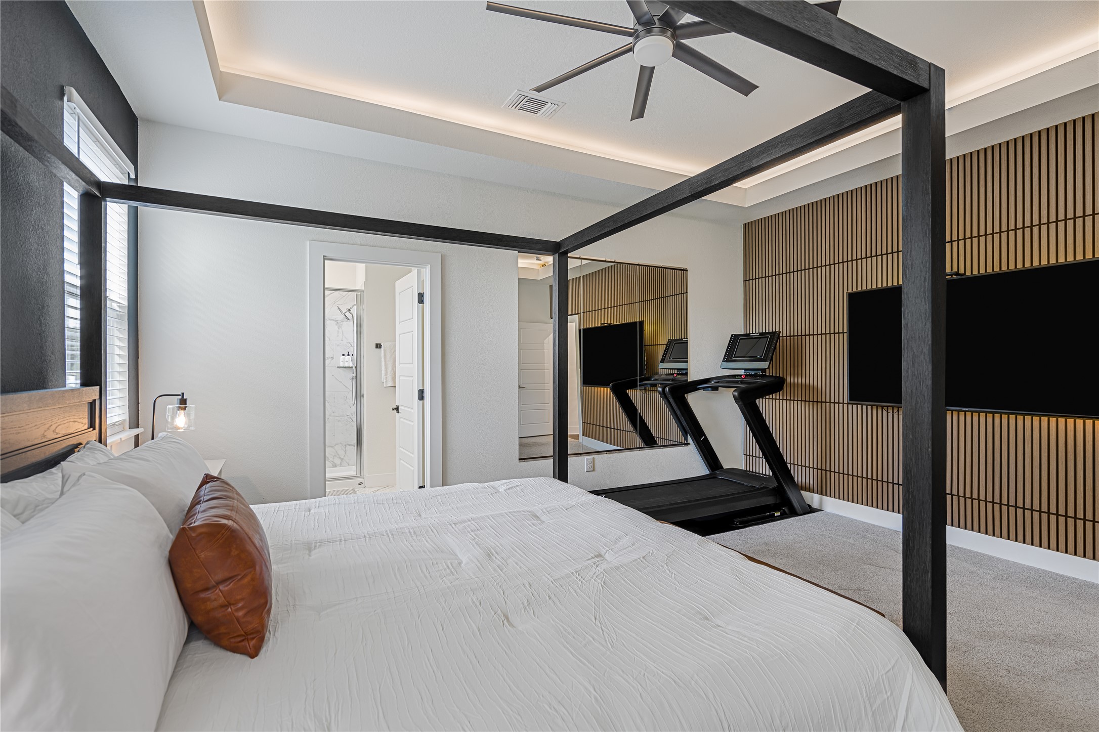 1811 Webberville Road, Unit 4103 Austin, TX 78721 - Photo 14 of 35 a bed room with a bed and a flat screen tv