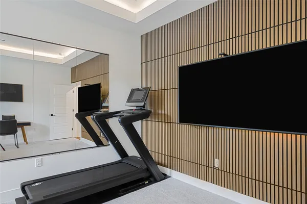 a living room with a flat screen tv on the wall a fireplace