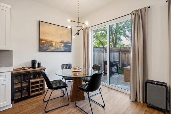 a kitchen with stainless steel appliances a table chairs and a refrigerator