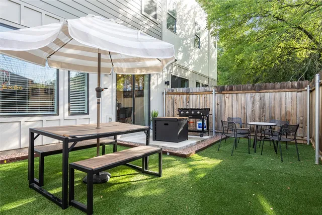 a view of a patio with table and chairs