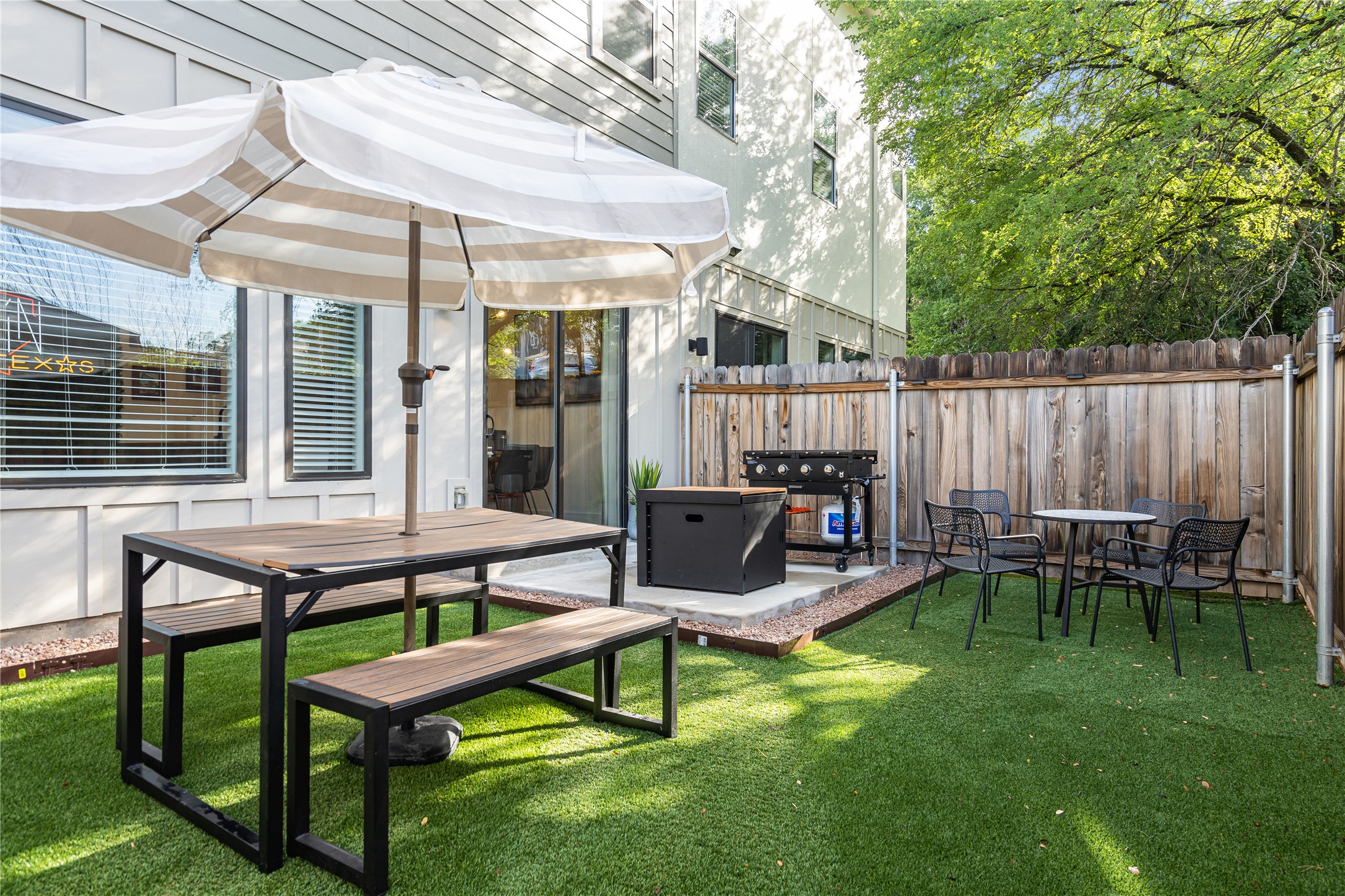 1811 Webberville Road, Unit 4103 Austin, TX 78721 - Photo 34 of 35 a view of a patio with table and chairs