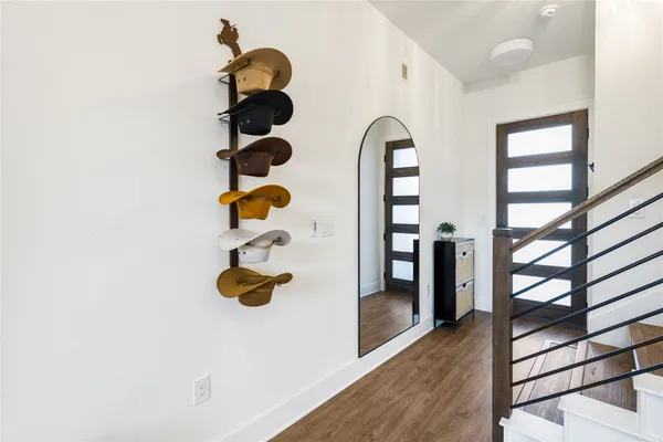 a picture of a room with wooden floor and windows
