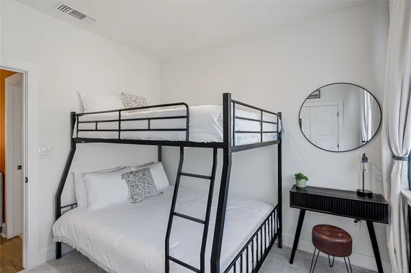 a bedroom with bed and a chandelier