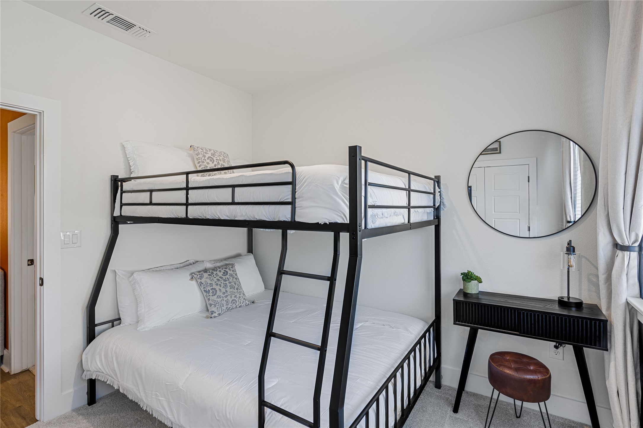 1811 Webberville Road, Unit 4103 Austin, TX 78721 - Photo 7 of 35 a bedroom with bed and a chandelier