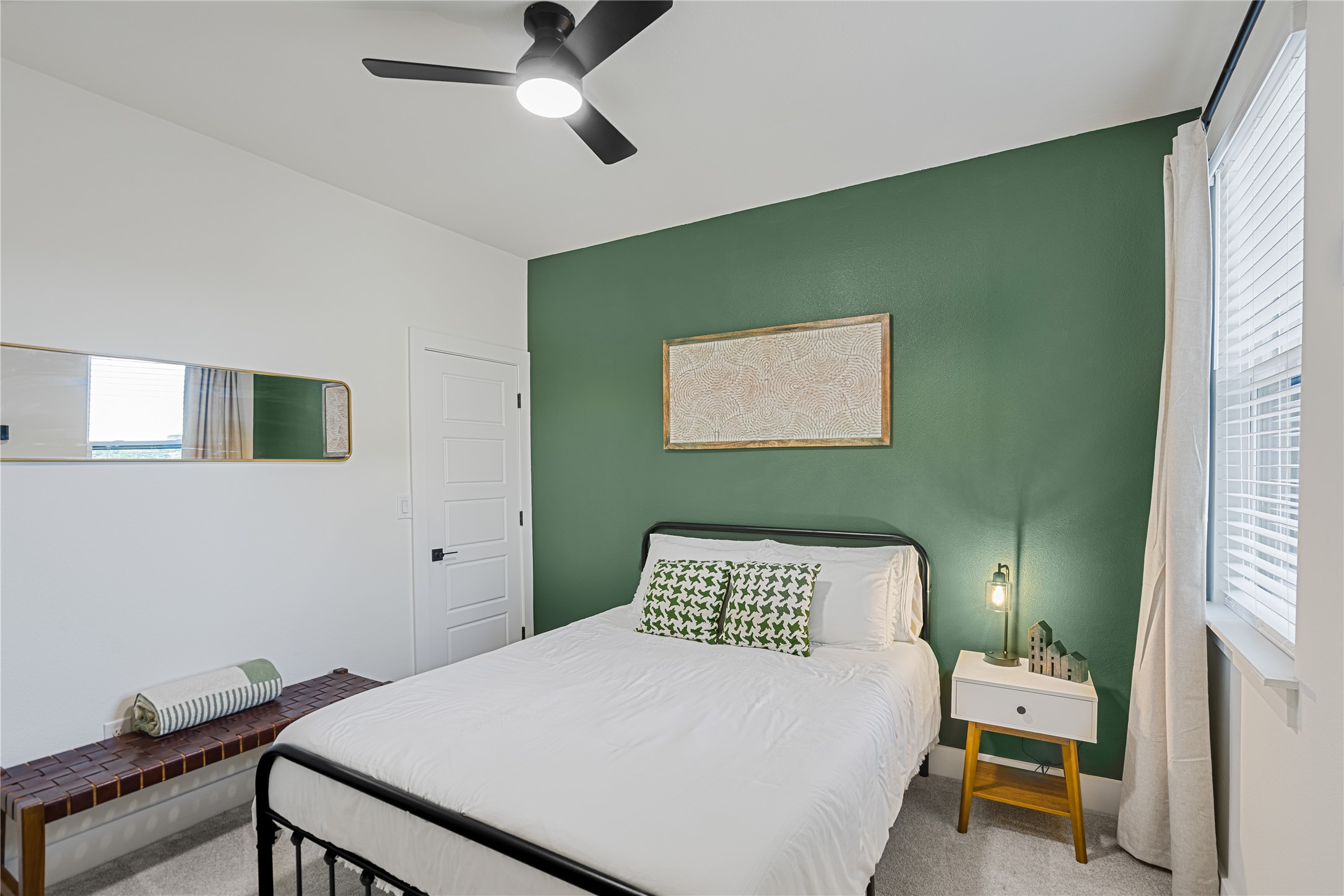 1811 Webberville Road, Unit 4103 Austin, TX 78721 - Photo 8 of 35 a bedroom with a bed and a chandelier