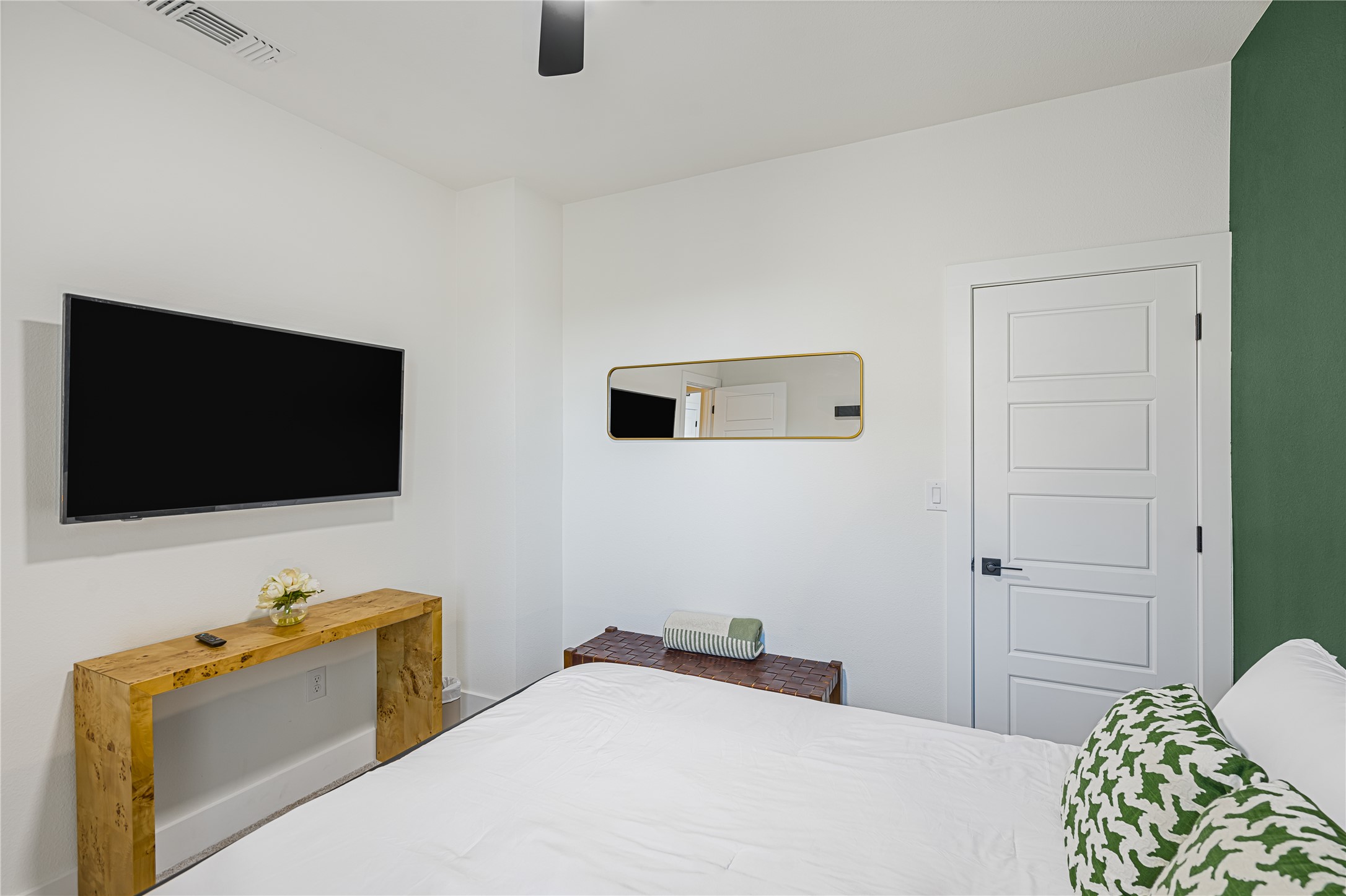 1811 Webberville Road, Unit 4103 Austin, TX 78721 - Photo 10 of 35 a bedroom with a bed and a flat screen tv