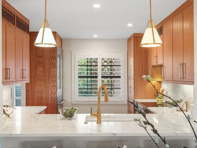 a room with a large window and chandelier