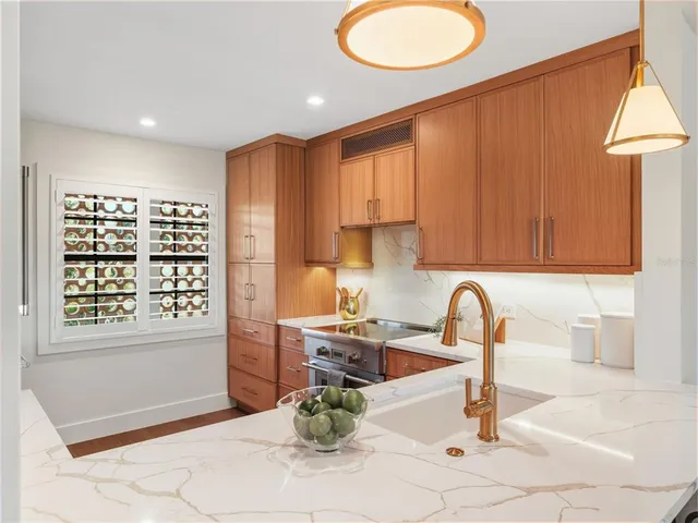 a kitchen with a sink a stove and a microwave