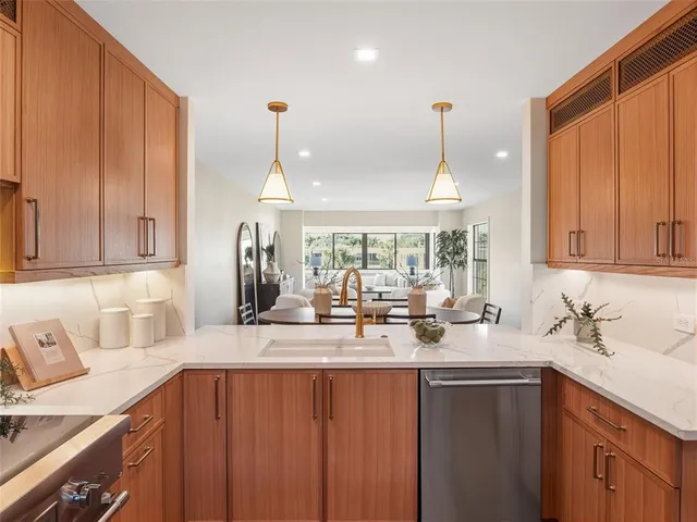 a kitchen with sink cabinets and chandelier