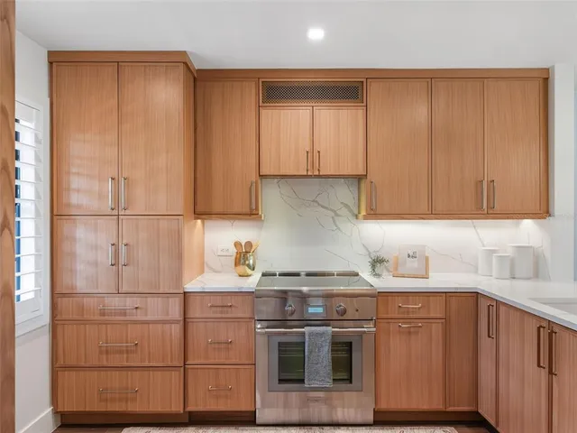 a kitchen with stainless steel appliances granite countertop a sink stove and cabinets
