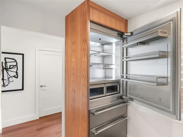 a view of walk in closet with empty racks
