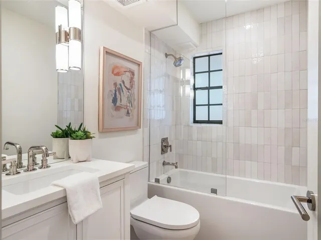 a bathroom with a sink a toilet and bathtub