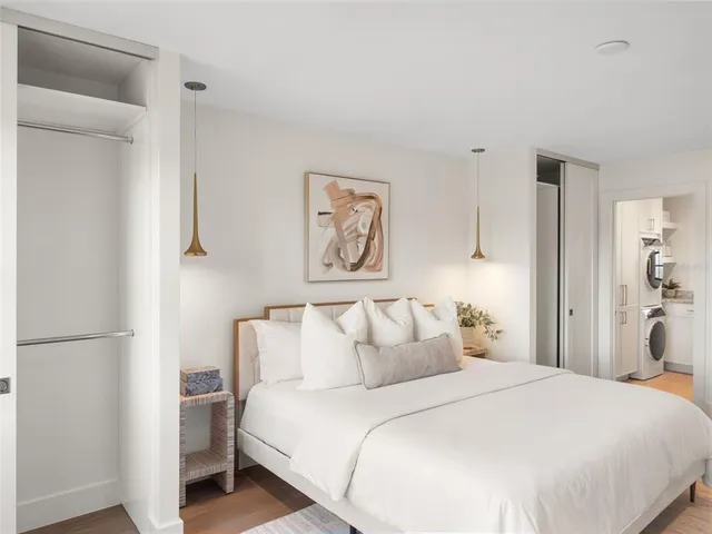 a bedroom with a bed and a painting on the wall