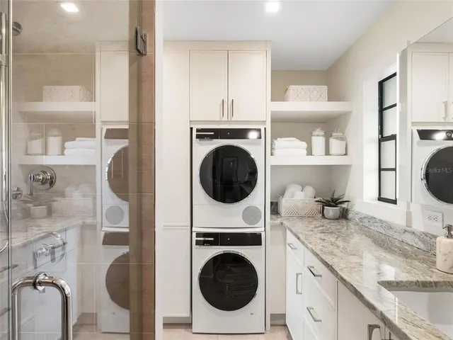 a utility room with sink dryer and washer