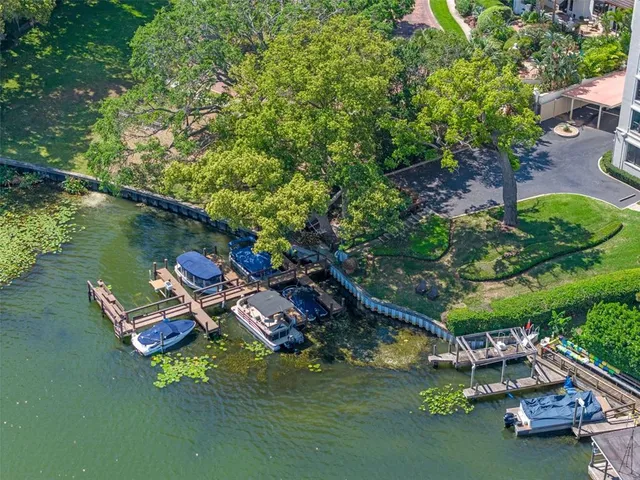 a view of a lake with lawn chairs