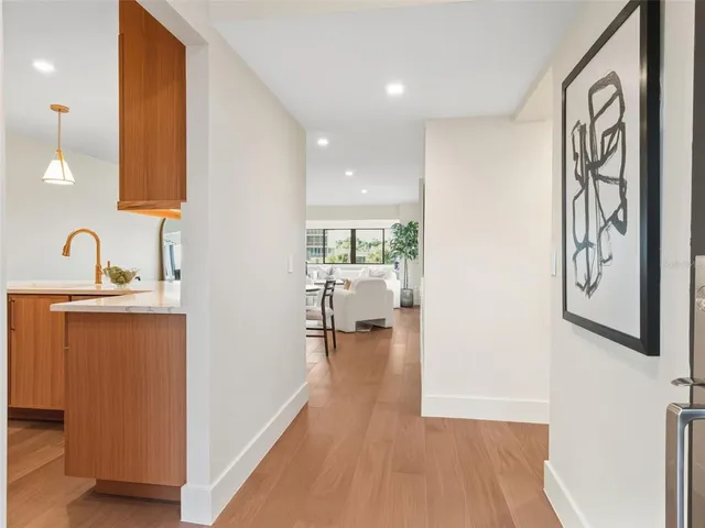 a hallway with a large mirror next to a window