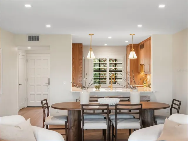 a view of a a dining room with furniture window and wooden floor