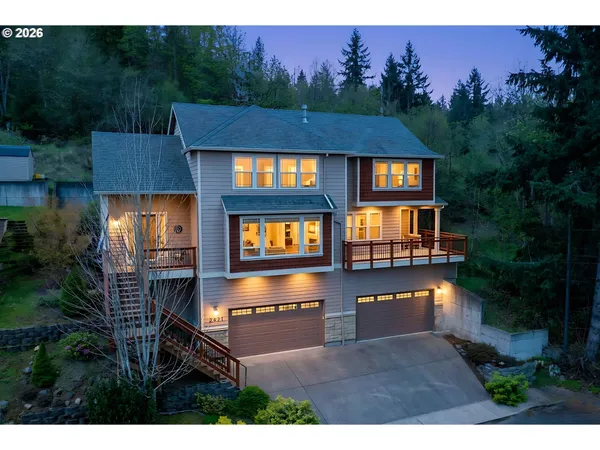 a view of a house with roof deck and seating space