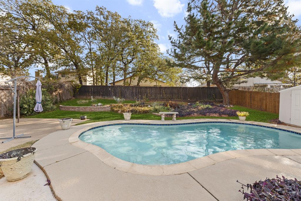3708 Windsong Lane Bedford, TX 76021 - Photo 14 of 29 a view of a swimming pool with a yard