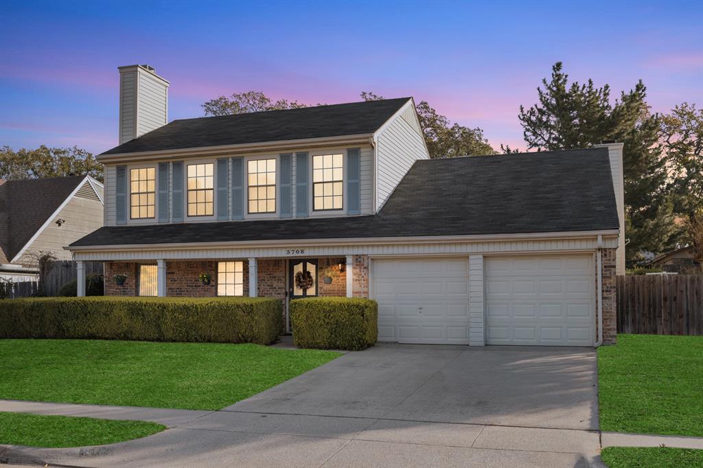 3708 Windsong Lane Bedford, TX 76021 - Photo 17 of 35 a front view of a house with a yard and garage