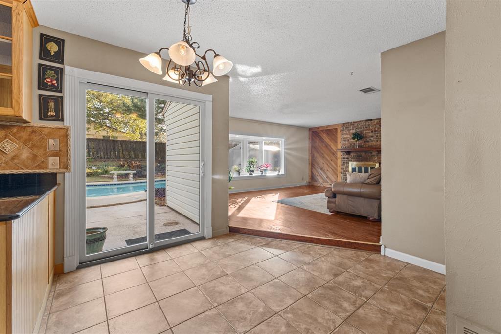 3708 Windsong Lane Bedford, TX 76021 - Photo 19 of 29 a very nice looking room with a large window and chandelier