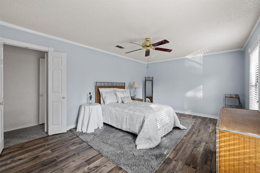 3708 Windsong Lane Bedford, TX 76021 - Photo 20 of 29 a bedroom with a bed and a chandelier