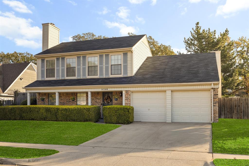 3708 Windsong Lane Bedford, TX 76021 - Photo 2 of 29 a front view of a house with a yard and garage