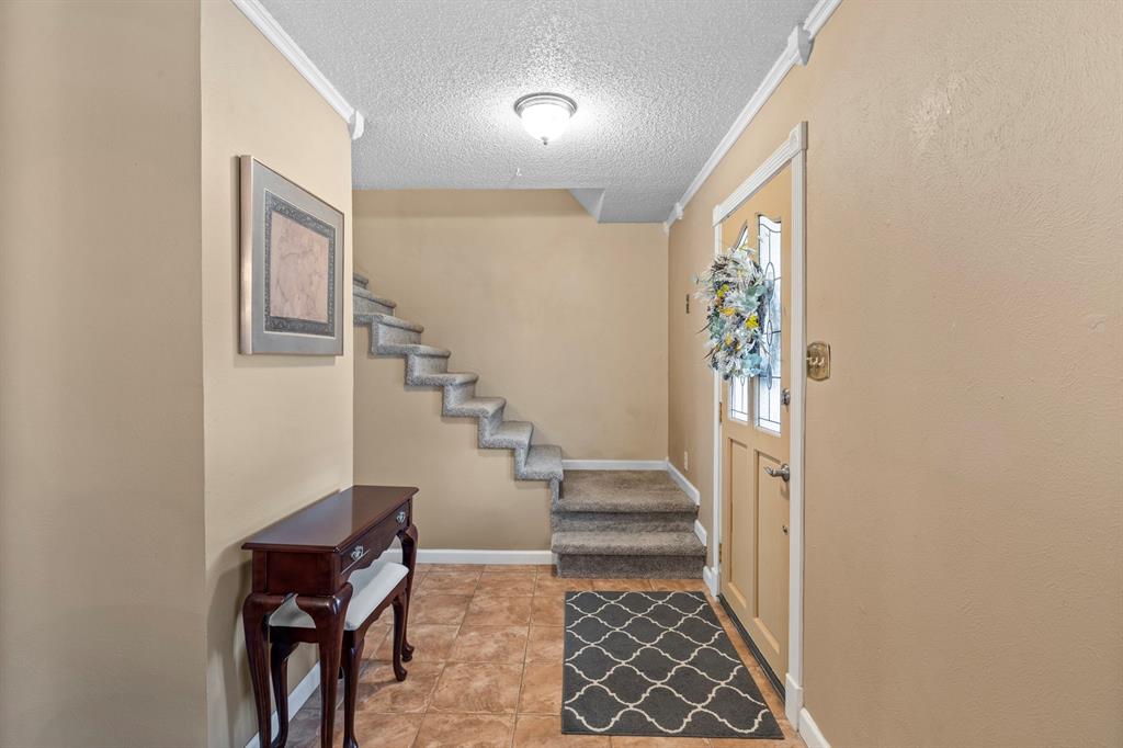 3708 Windsong Lane Bedford, TX 76021 - Photo 21 of 35 a view of entryway with stairs and furniture