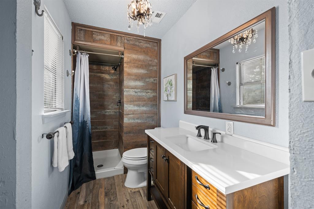 3708 Windsong Lane Bedford, TX 76021 - Photo 24 of 35 a bathroom with a sink toilet and shower