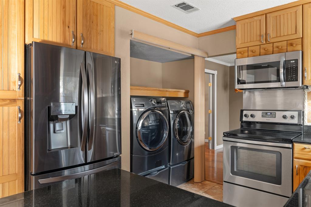 3708 Windsong Lane Bedford, TX 76021 - Photo 23 of 29 a kitchen with stainless steel appliances granite countertop a refrigerator and a stove top oven