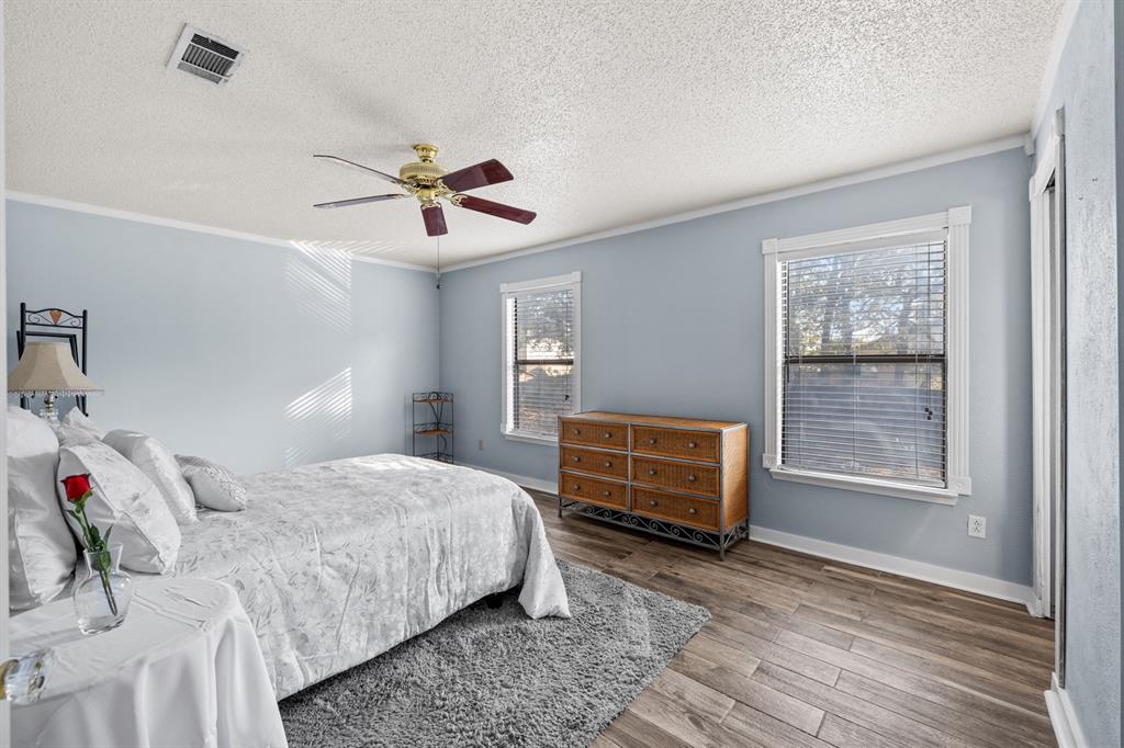 3708 Windsong Lane Bedford, TX 76021 - Photo 27 of 35 a bedroom with a bed and wooden floor