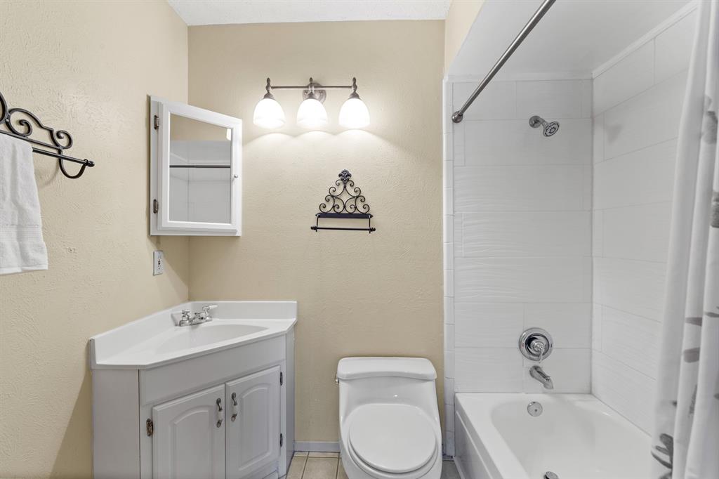 3708 Windsong Lane Bedford, TX 76021 - Photo 31 of 35 a bathroom with a toilet sink and mirror