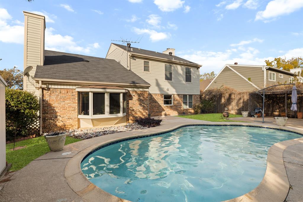 3708 Windsong Lane Bedford, TX 76021 - Photo 33 of 35 a view of a house with swimming pool and a yard