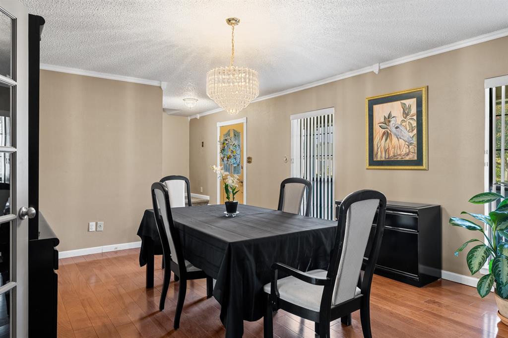 3708 Windsong Lane Bedford, TX 76021 - Photo 7 of 35 a view of a dining room with furniture window and wooden floor