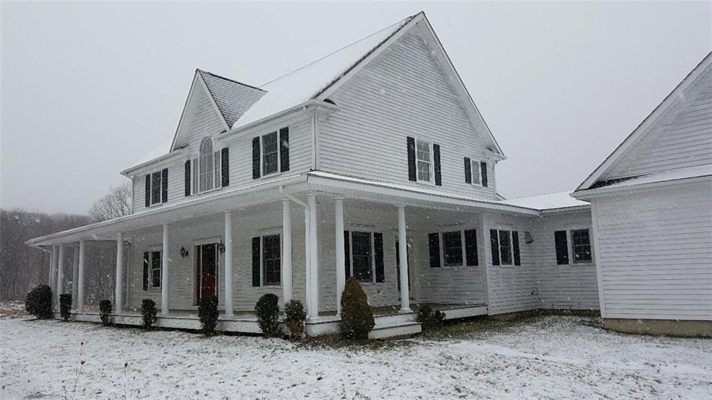 174 West Woods Road, Unit 2 Sharon, CT 06069 - Photo 1 of 1 a front view of a house with a yard