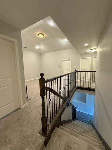 a view of entryway and hall with wooden floor