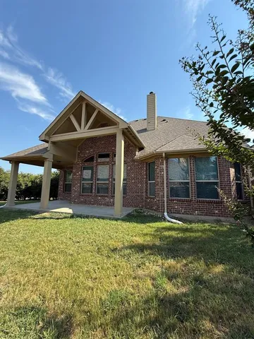 a front view of a house with a yard and porch