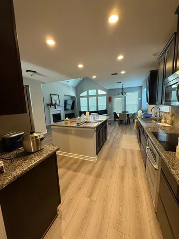 a kitchen with counter top space appliances and a center island