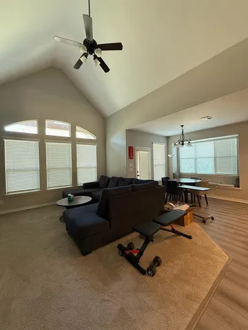 a open kitchen with a sink dishwasher a stove a oven with a dining table and chairs