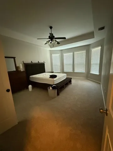 a living room with furniture gym equipment and a large window