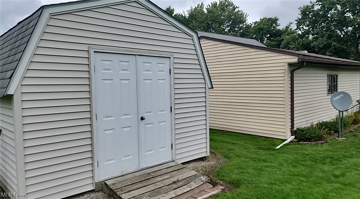 10966 Kile Road Chardon, OH 44024 - Photo 26 of 32 View of shed / structure featuring a storage unit and a yard