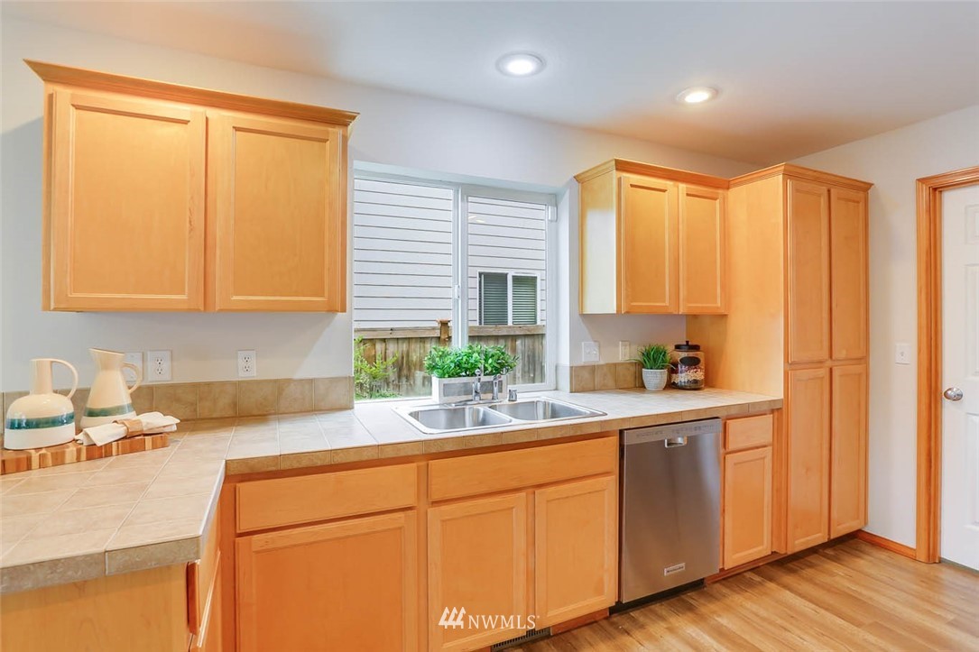 6731 Southeast 3rd Street Renton, WA 98059 - Photo 11 of 31 a kitchen with a sink a window and cabinets