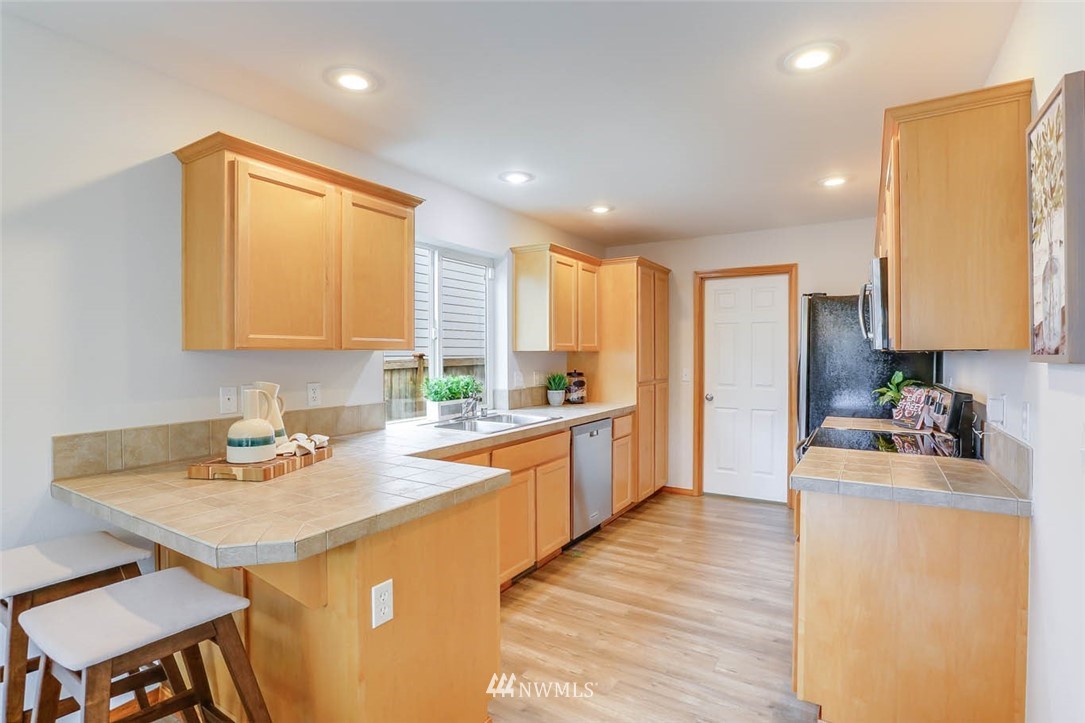 6731 Southeast 3rd Street Renton, WA 98059 - Photo 10 of 31 a kitchen with a sink stove and refrigerator