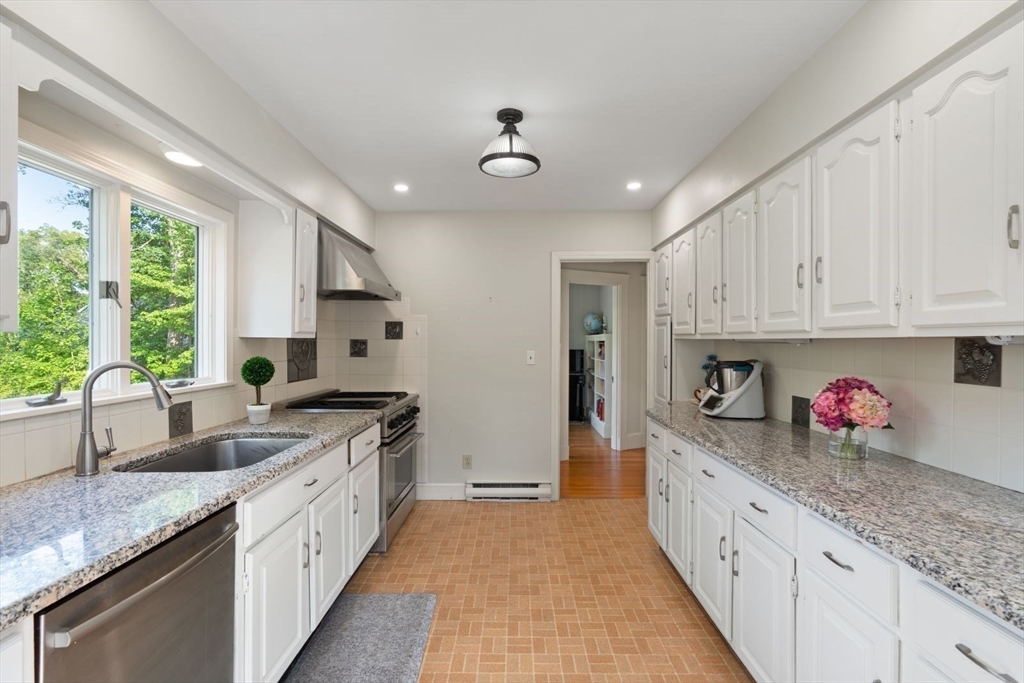 77 Meriam Street Lexington, MA 02420 - Photo 11 of 35 a kitchen with granite countertop a sink stainless steel appliances and cabinets