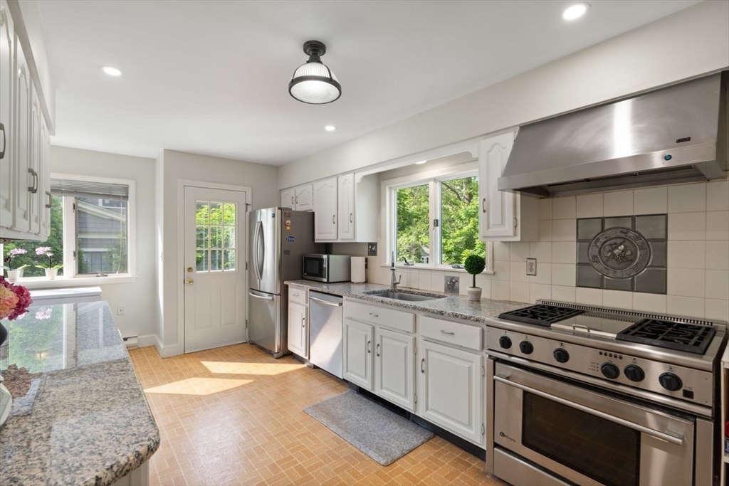77 Meriam Street Lexington, MA 02420 - Photo 13 of 35 a kitchen with a stove a sink and a refrigerator