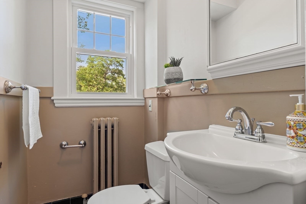 77 Meriam Street Lexington, MA 02420 - Photo 18 of 35 a bathroom with a sink a toilet and shower