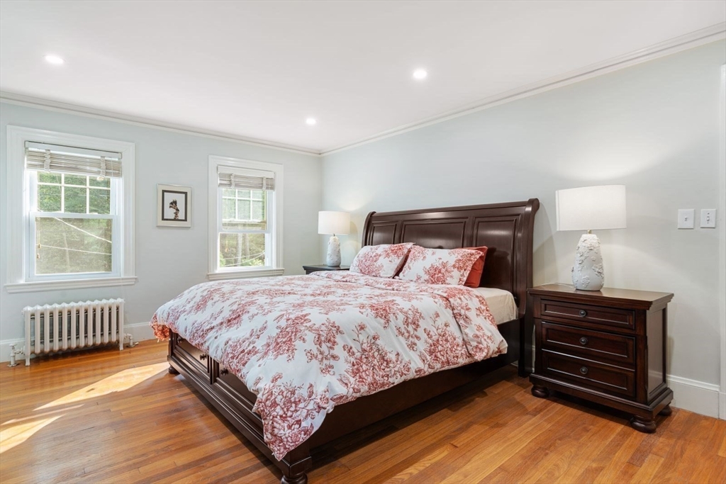 77 Meriam Street Lexington, MA 02420 - Photo 20 of 35 a bedroom with a bed wooden floor and window