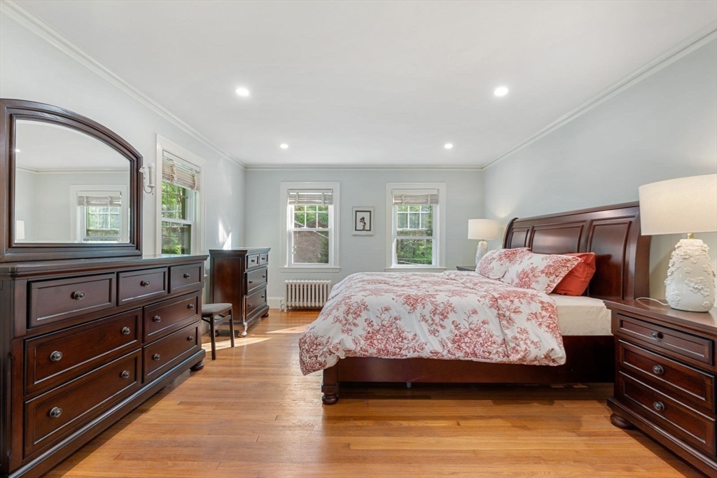 77 Meriam Street Lexington, MA 02420 - Photo 21 of 35 a bedroom with a bed and wooden floor